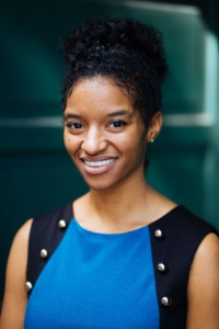 headshot of Jourdan wearing dress smiling.